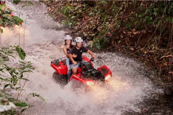 a man riding a bike down a dirt road