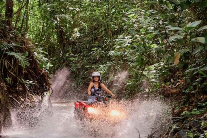a man riding on top of a river