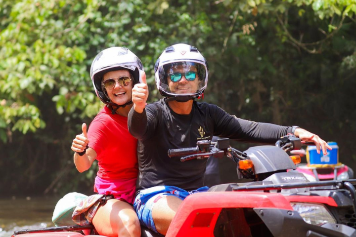 a group of people riding on the back of a motorcycle