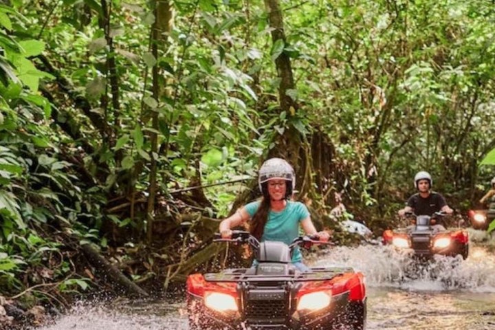 a man riding a bike down a dirt road