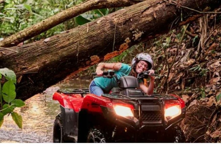 a person riding a bike down a dirt road
