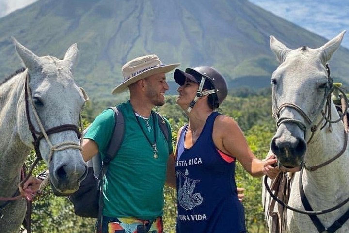 a couple of people standing next to a horse