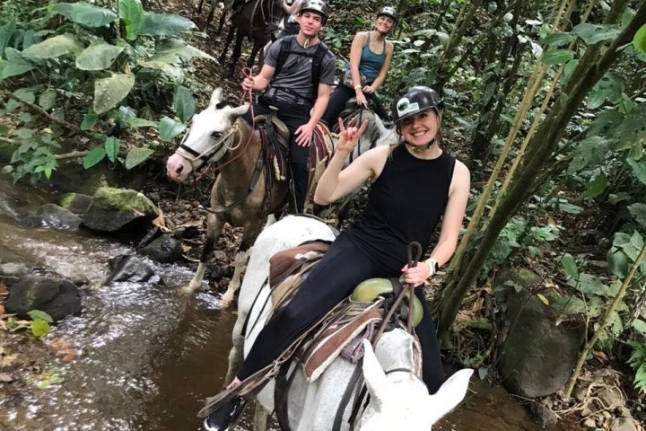 a man riding a elephant in the water
